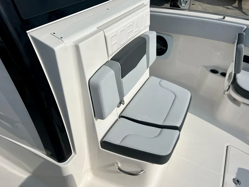 Slide: The Image of 2025 Robalo R300 boat interior with cushioned seating and sleek design. - 30