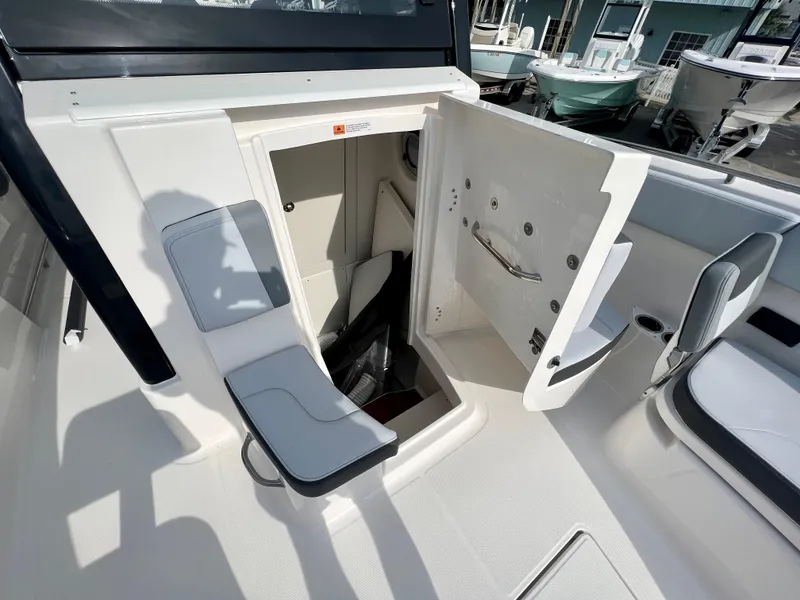 Slide: The Image of 2025 Robalo R300 boat interior with open storage compartment and seating area. - 31