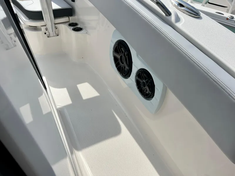 Slide: The Image of 2025 Robalo R300 boat interior with dual speakers and seating area. - 35