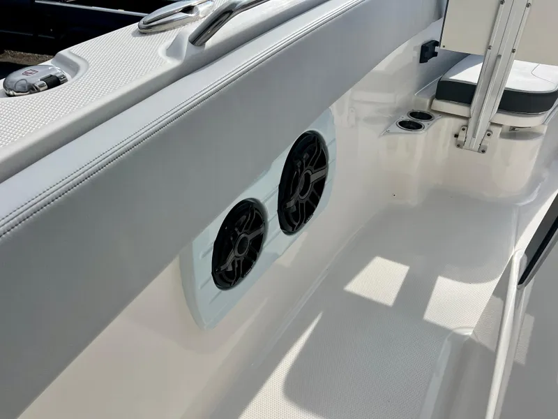 Slide: The Image of 2025 Robalo R300 boat interior with speakers and seating area. - 36