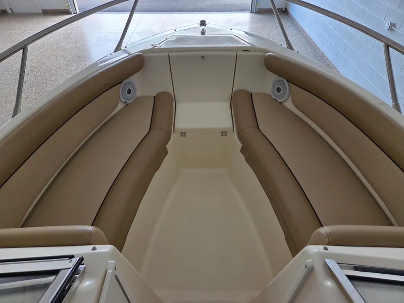 Slide: The Image of 2017 Scout 225 Dorado boat interior with tan cushioned seating and stainless steel railings. - 15