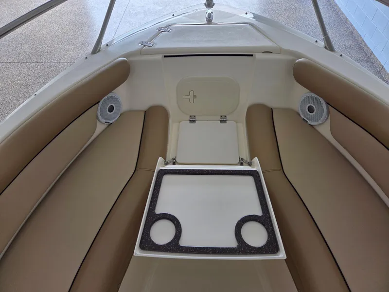 Slide: The Image of 2017 Scout 225 Dorado boat interior with beige seating and cup holders. - 16