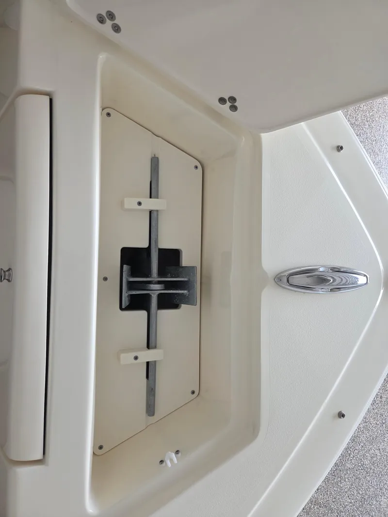 Slide: The Image of 2017 Scout 225 Dorado boat interior detail, featuring a storage compartment and latch mechanism. - 17