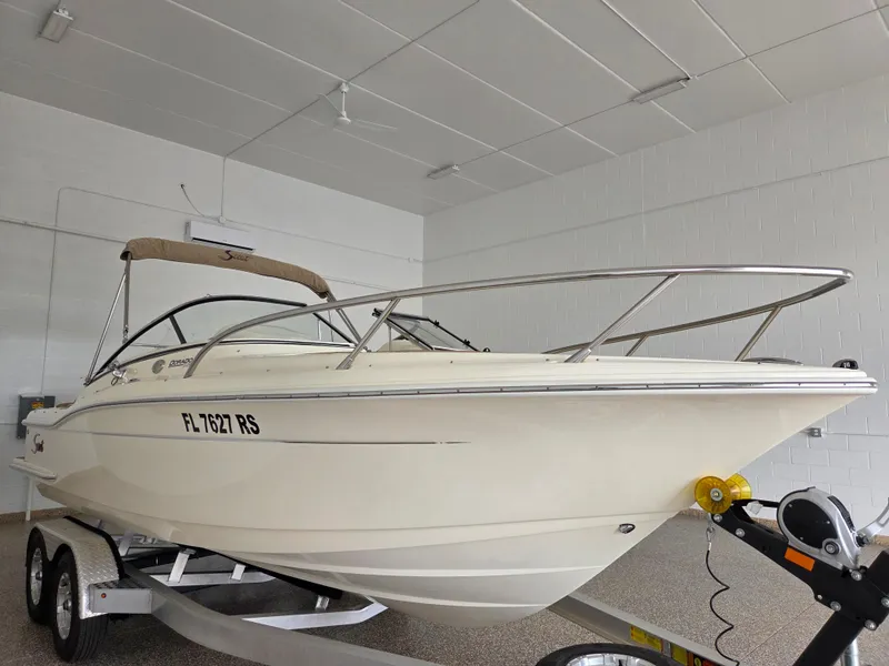 Slide: The Image of 2017 Scout 225 Dorado boat on trailer in indoor storage. - 2
