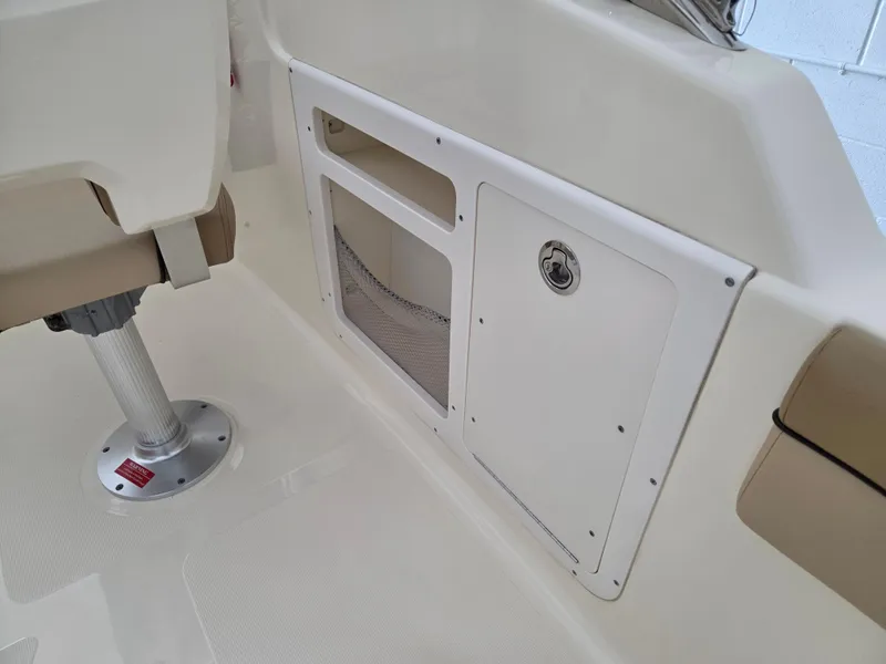 Slide: The Image of 2017 Scout 225 Dorado boat interior storage compartment and seating area. - 20