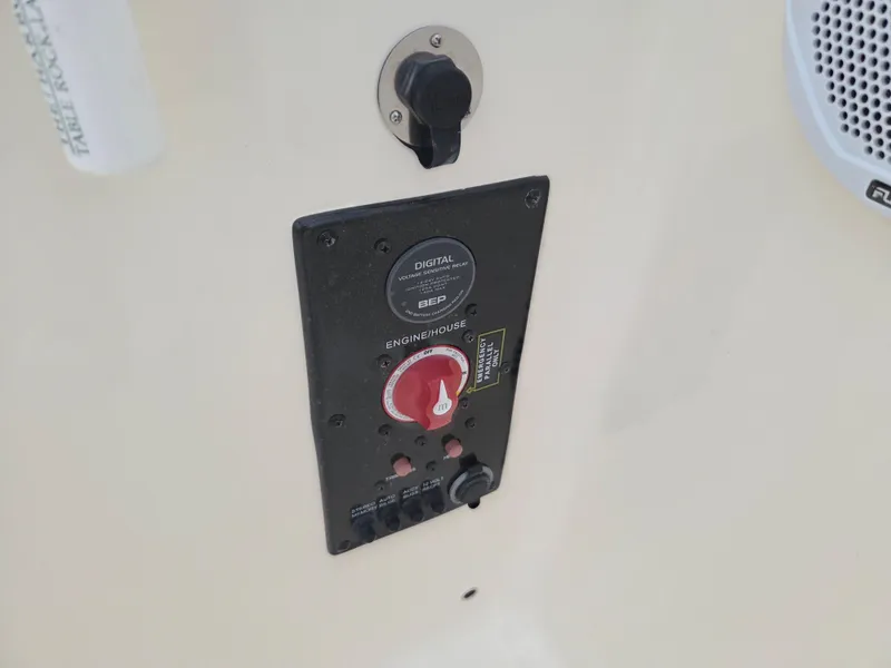 Slide: The Image of Control panel on a 2017 Scout 225 Dorado boat, featuring switches and a speaker. - 21