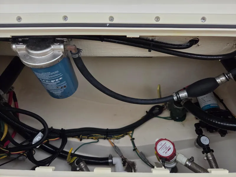 Slide: The Image of 2017 Scout 225 Dorado boat engine compartment with hoses and wiring. - 22