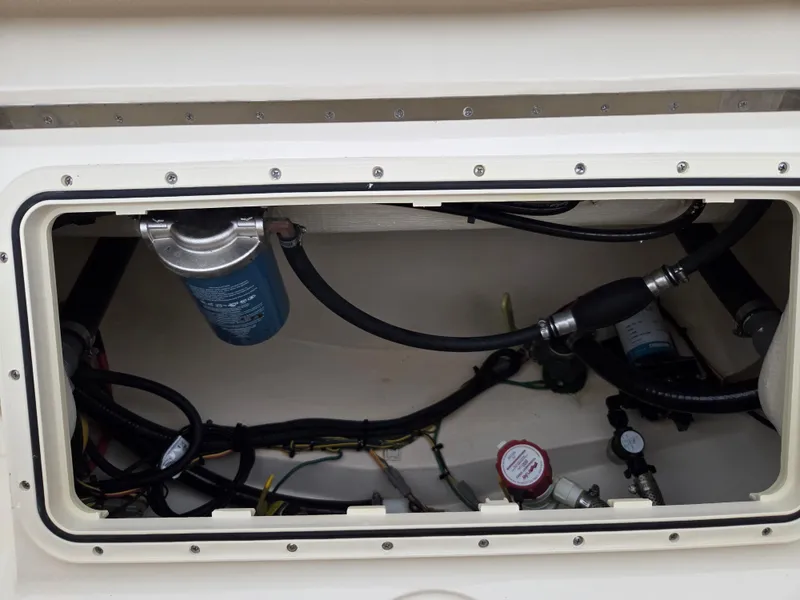 Slide: The Image of 2017 Scout 225 Dorado boat compartment with wiring and filter system. - 23