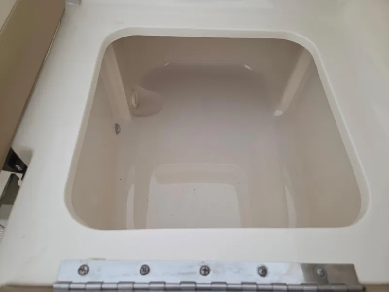 Slide: The Image of Storage compartment on a 2017 Scout 225 Dorado boat, featuring a hinged lid. - 25