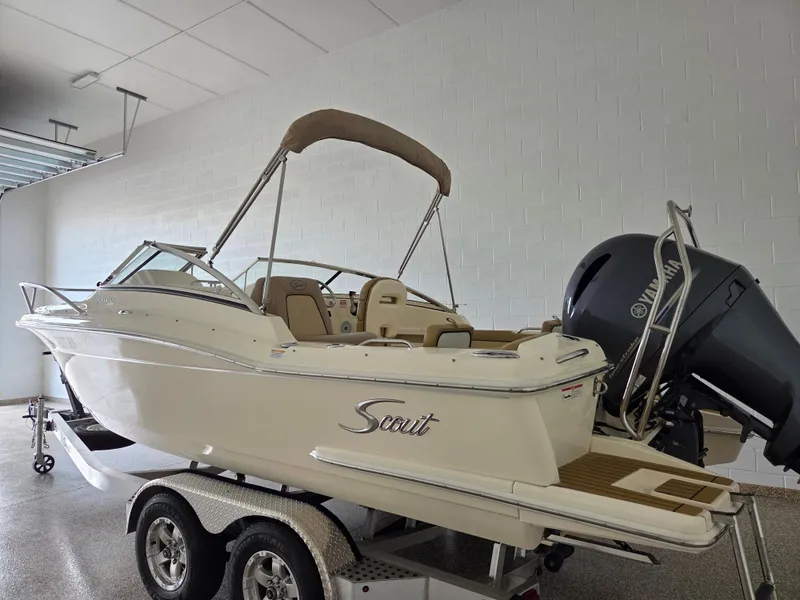 Slide: The Image of 2017 Scout 225 Dorado boat on trailer in garage, featuring Yamaha outboard motor. - 3