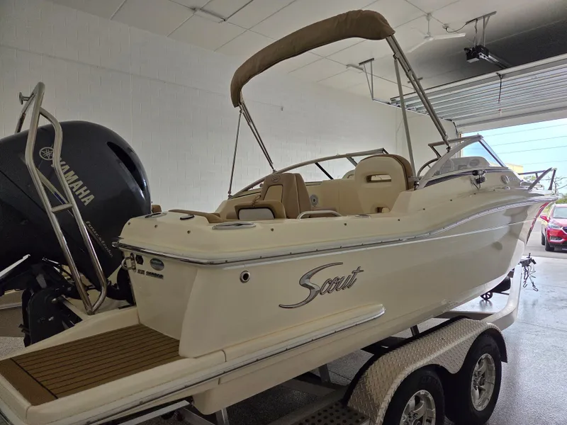 Slide: The Image of 2017 Scout 225 Dorado boat on trailer in garage, featuring Yamaha engine. - 4