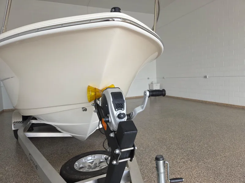 Slide: The Image of 2017 Scout 225 Dorado boat on trailer in garage setting. - 5