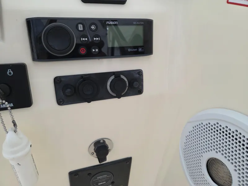 Slide: The Image of Control panel of a 2017 Scout 225 Dorado boat with audio system and speaker. - 9