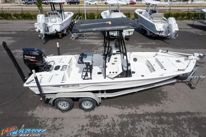 Slide: The Image of 2016 Blue Wave 2200 STL boat on trailer, equipped with Suzuki outboard motor. - 13