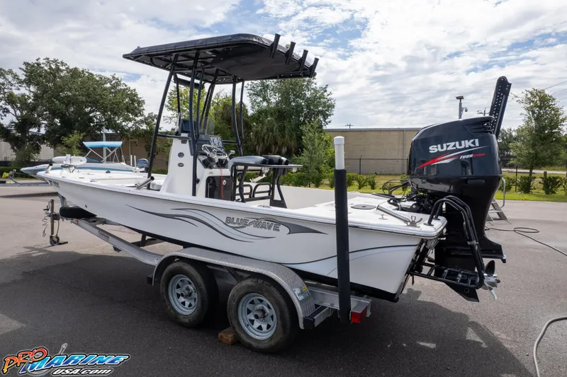 Slide: The Image of 2016 Blue Wave 2200 STL boat on trailer with Suzuki outboard motor. - 4