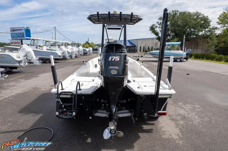 Slide: The Image of 2016 Blue Wave 2200 STL boat with 175 HP engine, displayed outdoors. - 6