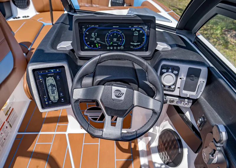 Slide: The Image of 2024 Malibu Wakesetter 24 MXZ dashboard with advanced digital controls and steering wheel. - 15
