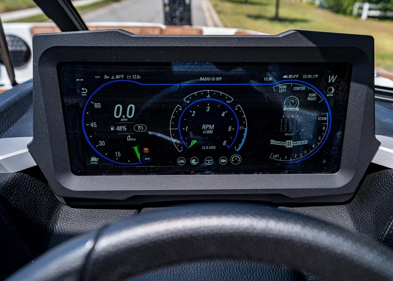 Slide: The Image of 2024 Malibu Wakesetter 24 MXZ dashboard display with digital gauges and controls. - 16