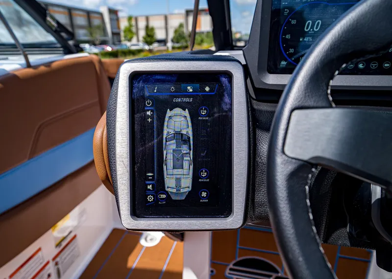 Slide: The Image of 2024 Malibu Wakesetter 24 MXZ dashboard with touchscreen controls and steering wheel. - 17