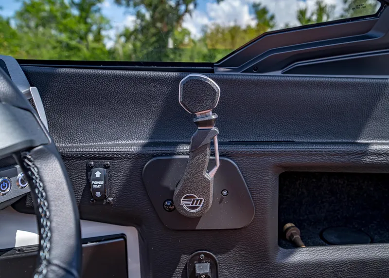 Slide: The Image of 2024 Malibu Wakesetter 24 MXZ dashboard with control lever and buttons. - 19