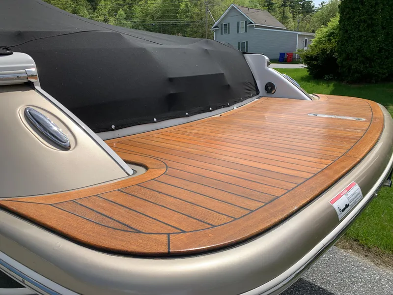 Slide: The Image of 2012 Chris-Craft Launch 28 boat with teak swim platform, parked outdoors. - 11