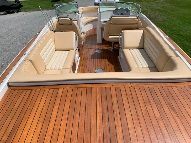 Slide: The Image of 2012 Chris-Craft Launch 28 boat with elegant wood deck and beige seating. - 13