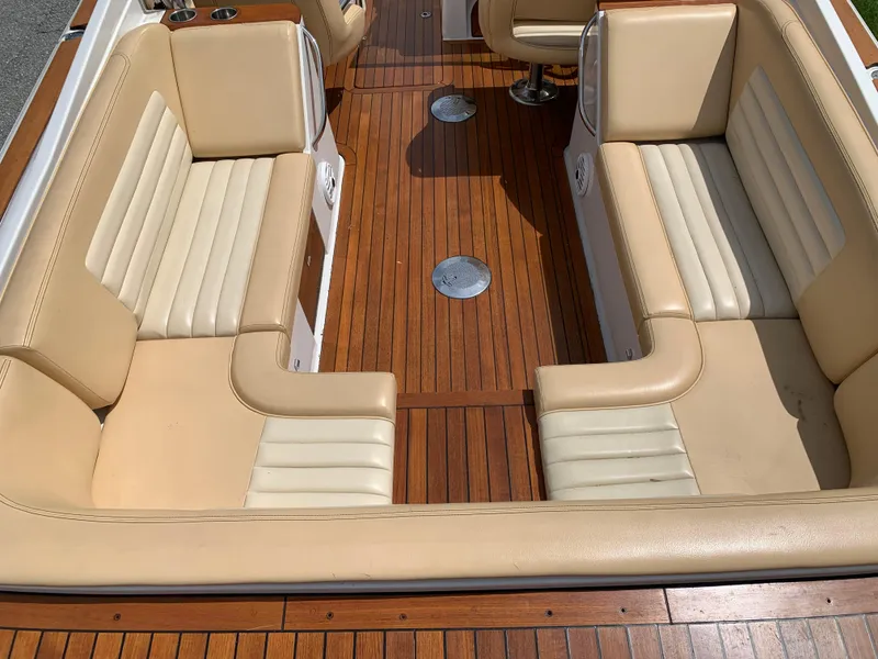 Slide: The Image of 2012 Chris-Craft Launch 28 interior with tan leather seats and wooden flooring. - 15