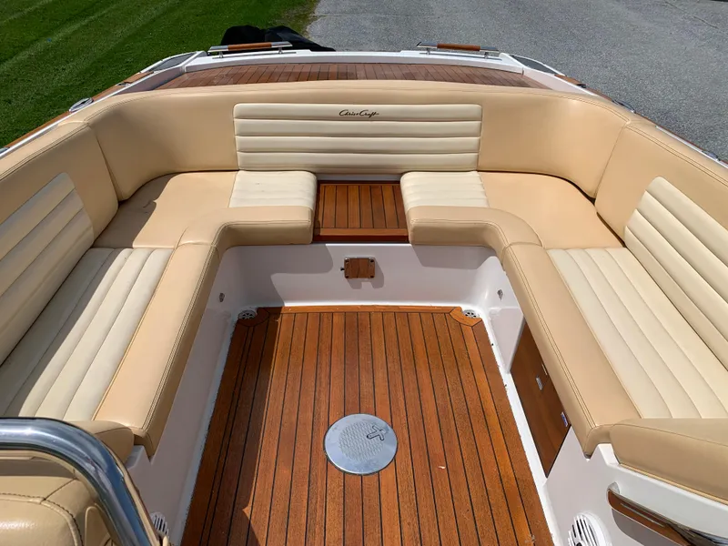 Slide: The Image of 2012 Chris-Craft Launch 28 boat interior with tan leather seating and wooden flooring. - 20