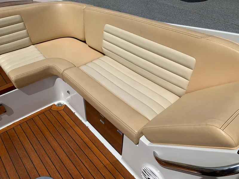 Slide: The Image of 2012 Chris-Craft Launch 28 boat interior with tan leather seating and wooden flooring. - 21