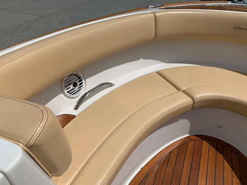 Slide: The Image of 2012 Chris-Craft Launch 28 boat interior with tan leather seating and wooden flooring. - 25