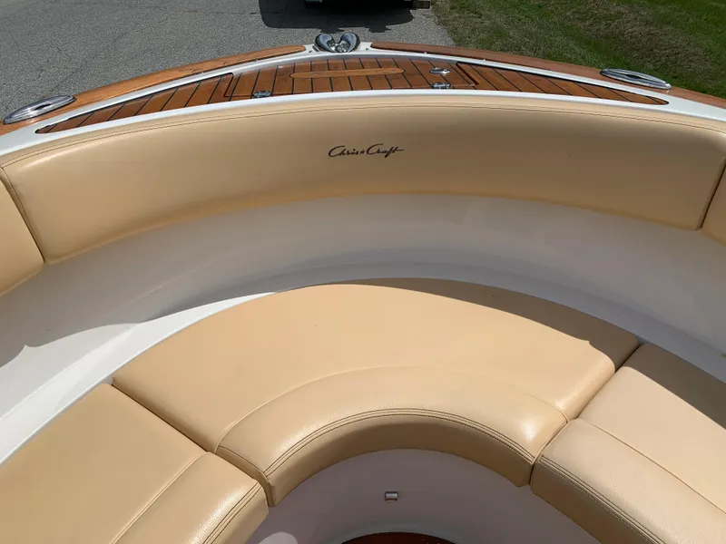 Slide: The Image of 2012 Chris-Craft Launch 28 boat with beige leather seating and wooden accents. - 26