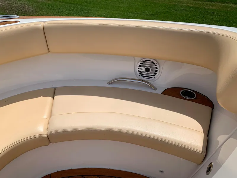 Slide: The Image of 2012 Chris-Craft Launch 28 boat interior with beige seating and speaker. - 27
