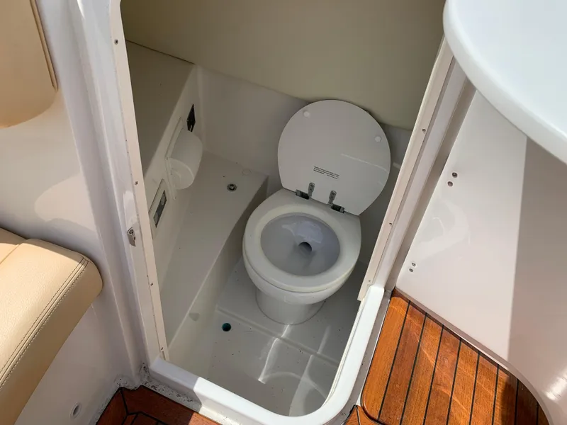 Slide: The Image of 2012 Chris-Craft Launch 28 boat interior with a compact marine toilet. - 30