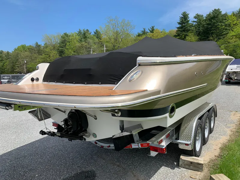 Slide: The Image of 2012 Chris-Craft Launch 28 boat on trailer, covered, in outdoor setting. - 9