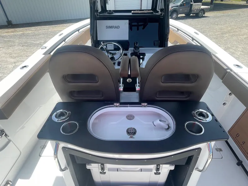 Slide: The Image of 2025 Sea Pro 292 Offshore boat interior with helm, seating, and sink station. - 13