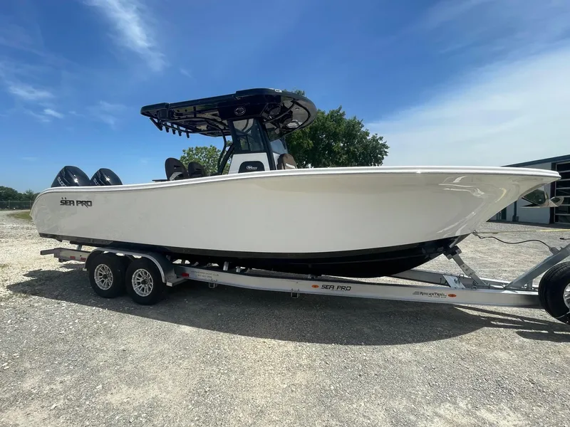 Slide: The Image of 2025 Sea Pro 292 Offshore boat on trailer under clear blue sky. - 3