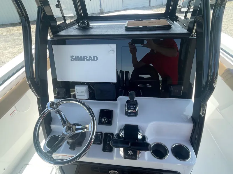Slide: The Image of 2025 Sea Pro 292 Offshore boat dashboard with Simrad electronics and steering wheel. - 9