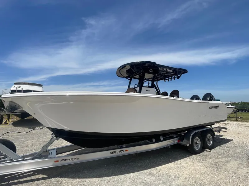Slide: The Image of 2025 Sea Pro 292 Offshore boat on trailer under clear blue sky. - 2