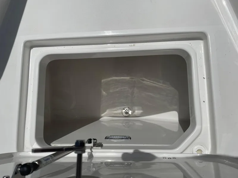 Slide: The Image of 2025 Sea Pro 292 Offshore storage compartment, open and empty, showcasing interior space. - 20
