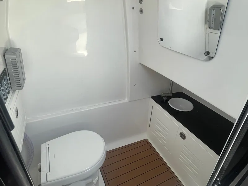 Slide: The Image of 2025 Sea Pro 292 Offshore boat bathroom with modern fixtures and wood-style flooring. - 21