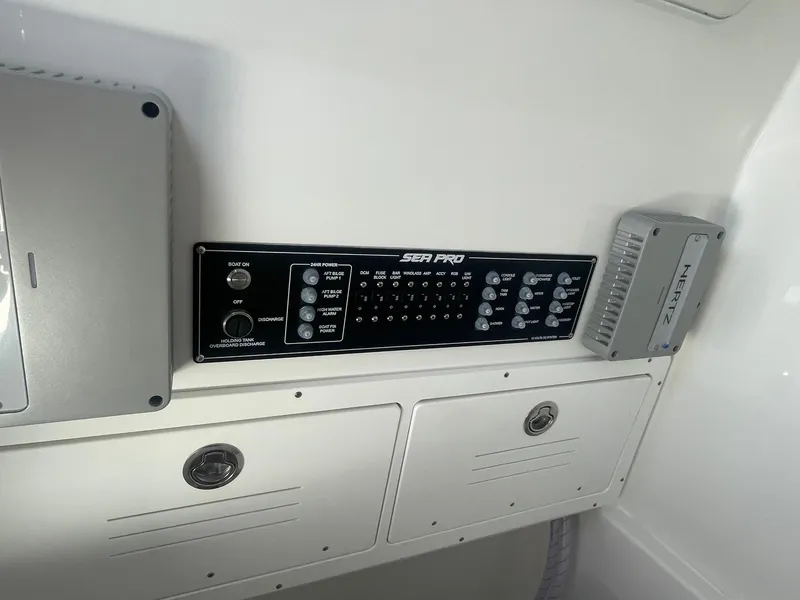 Slide: The Image of 2025 Sea Pro 292 Offshore control panel with storage compartments. - 22