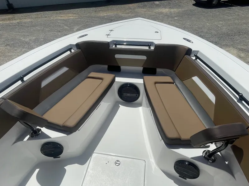Slide: The Image of 2025 Sea Pro 292 Offshore boat interior with cushioned seating and speakers. - 6
