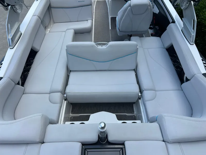 Slide: The Image of 2018 MasterCraft XT23 boat interior with luxurious white seating and modern design. - 11