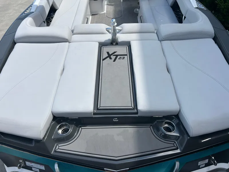 Slide: The Image of 2018 MasterCraft XT23 boat interior with sleek seating and modern design. - 4