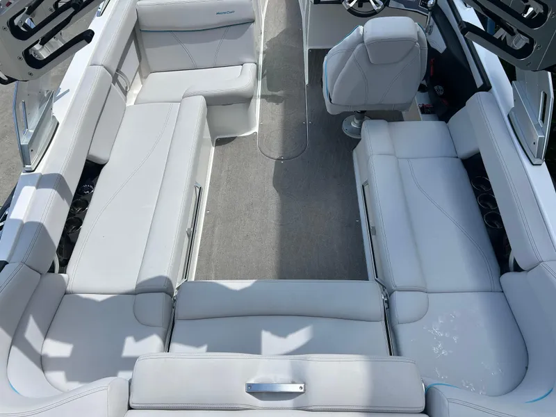 Slide: The Image of 2018 MasterCraft XT23 boat interior with white seating and steering wheel. - 5