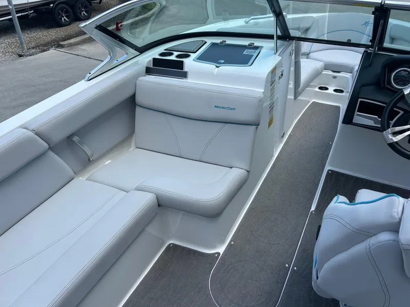 Slide: The Image of 2018 MasterCraft XT23 boat interior with white seating and modern dashboard. - 7