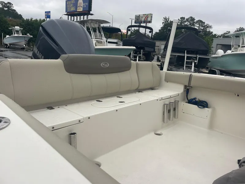 Slide: The Image of 2021 Key West 239 FS boat interior with seating and storage, displayed outdoors. - 4