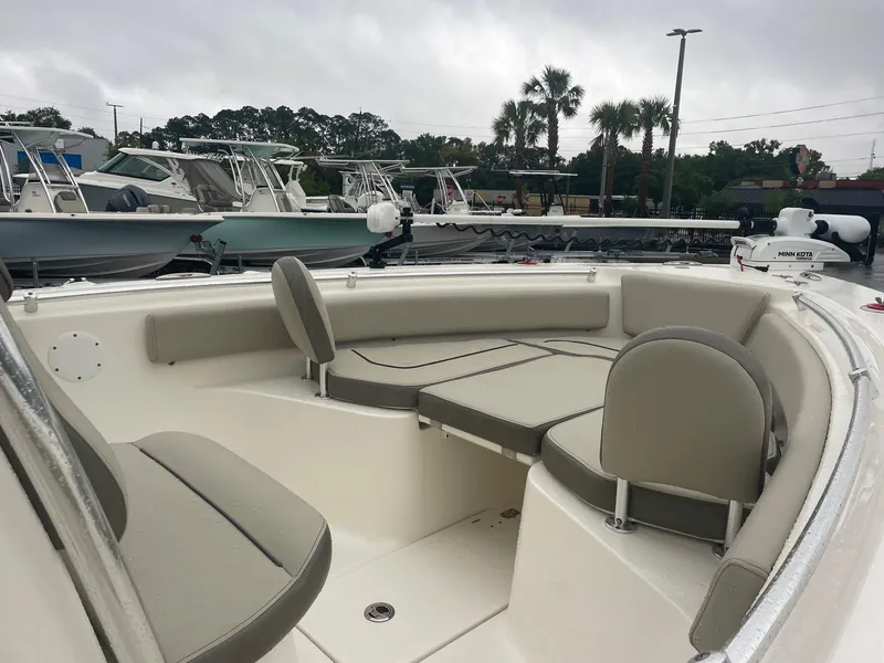 Slide: The Image of 2021 Key West 239 FS boat with spacious seating, docked in a marina. - 5