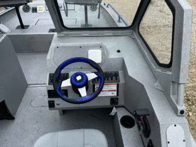 Slide: The Image of 2025 SeaArk ProCat 240 boat interior with steering wheel and control panel. - 8