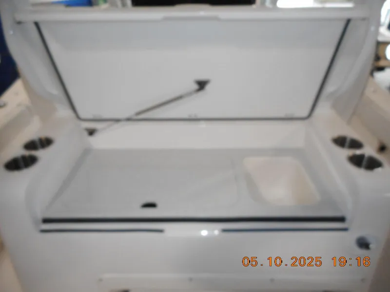 Slide: The Image of 2025 Sea Fox 328 Commander boat storage compartment with cup holders. - 16